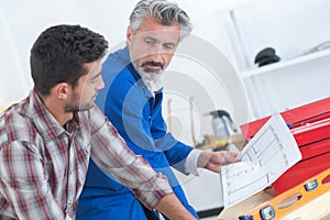 Plumber and inspector looking at plans