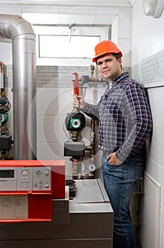 Plumber installing heating system at boiler room