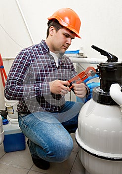 Plumber installing manometer on high pressure barrel