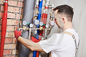 Plumber installing and mounting water equipment - meter, filter and pressure reducer