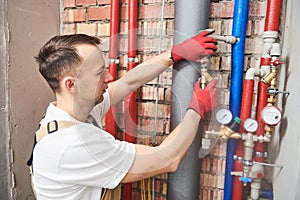 Plumber installing and mounting water equipment - meter, filter and pressure reducer