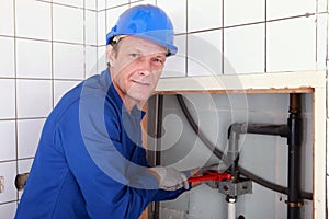 Plumber installing pipes