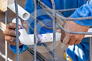 Plumber Installing PVC Pipe at Construction Site