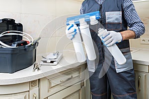 Plumber installing or repairing system of water filtration.