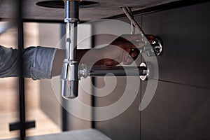 Plumber Installing The Sink In Bathroom Close-up Photo, Cropped Black Man