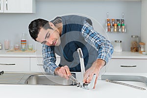 Plumber installing tap