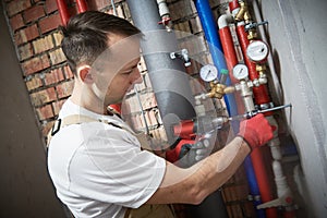 Plumber installing water equipment - meter, filter and pressure reducer