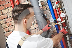 Plumber installing water equipment - meter, filter and pressure reducer