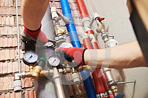 Plumber installing water equipment - meter, filter and pressure reducer