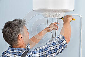 Plumber installing water heater