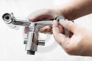 Plumber installs paronite gasket in faucet closeup