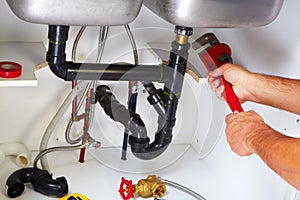 Plumber on the kitchen. photo