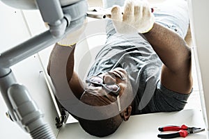 Plumber man fixing kitchen sink