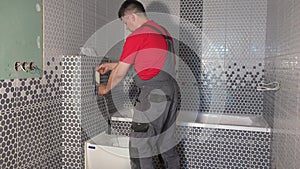 Plumber man flush water from tube of toilet flushing mechanism