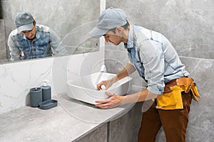 plumber man repair leaky faucet tap
