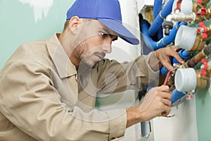 plumber man repair leaky faucet tap