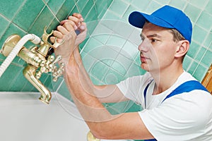 Plumber man repair leaky faucet tap