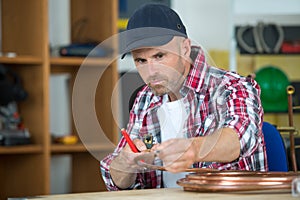 Plumber marking copper pipe