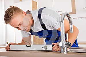 Plumber Measuring Level Of A Sink