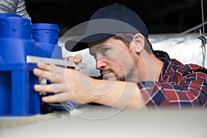 plumber measuring pipe