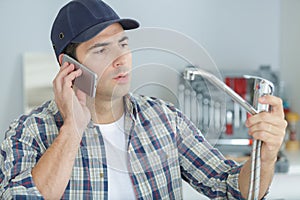 Plumber on phone talking to customer on phone