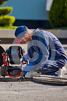 The plumber with portable camera for pipe inspection and other plumbing work