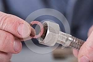 Plumber putting a gasket on a plumbing fitting