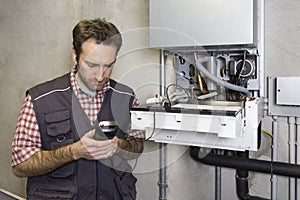 Plumber repairing a condensing boiler
