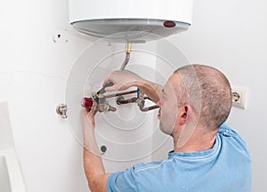 Plumber repairing an electric boiler