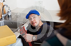 Plumber repairing a kitchen sink