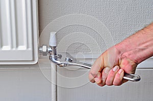 Plumber repairing a radiator pipe