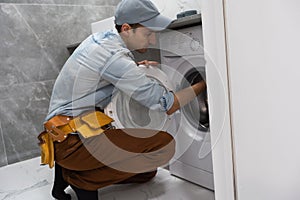 Plumber repairman repairing washing machine