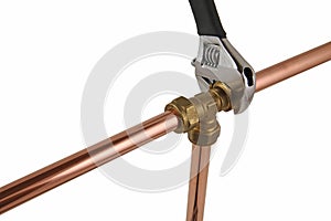 Plumber`s adjustable wremch tightening up copper pipework