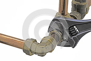 Plumber& x27;s adjustable wrench tightening up copper pipework