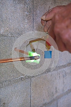 Plumber soldering copper pipe