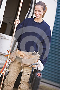 Plumber standing with van