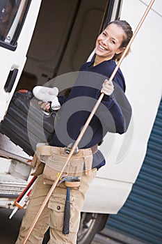 Plumber standing with van