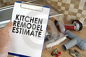 Plumber taking clipboard with kitchen remodel estimate.
