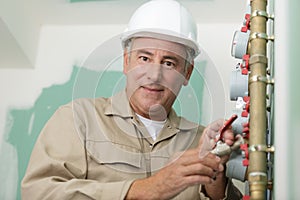 Plumber technician works with water meter