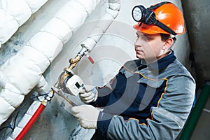 Plumber technician works with water meter