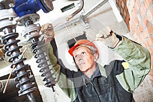 Plumber technician works with water pump