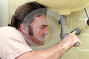 Plumber Tightening Pipe
