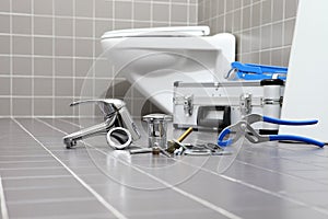 plumber tools and equipment in a bathroom, plumbing repair service, assemble and install concept photo