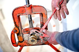 Plumber using adjustable wrench for copper pipes instalation