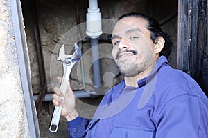 Plumber using large adjustable wrench