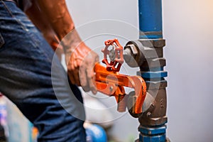 Plumber using a wrench to repair and remove the water supply pipe and valve