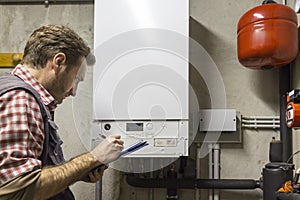 Plumber who carries out the maintenance of a condensing boiler