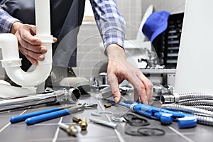 Plumber at work in a bathroom, plumbing repair service, assemble