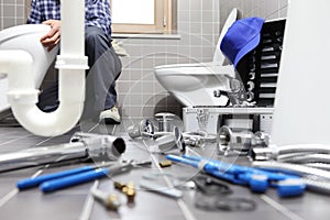 Plumber at work in a bathroom, plumbing repair service, assemble