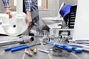 Plumber at work in a bathroom, plumbing repair service, assemble